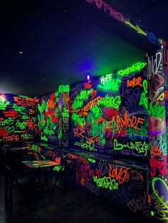 the walls are covered in graffiti and neon lights