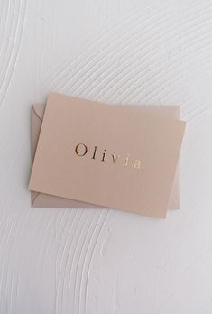 two folded cards with the word livva printed on them sitting on a white surface