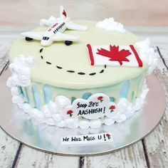 a cake decorated with an airplane and canadian flag