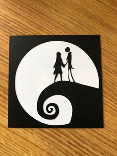 the silhouettes of two people are holding hands in front of a black and white background