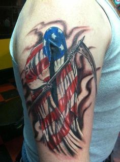 a man's arm with an american flag tattoo on it, and a bird