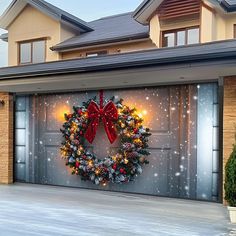 a christmas wreath on the side of a garage door in front of a house with lights