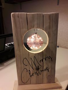 a wooden box with a christmas ornament in it