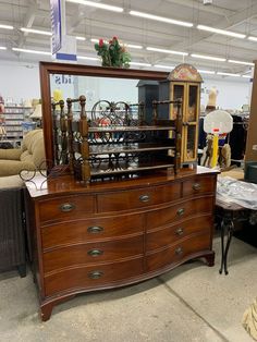 a large wooden dresser sitting inside of a store