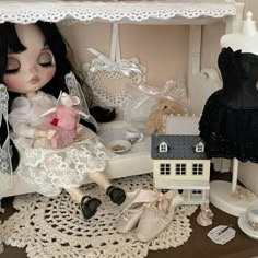 there is a doll and other items on the table