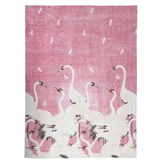 a pink rug with white birds on it and two swans in the foreground, against a pink background