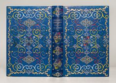 an open blue book with intricate designs on it