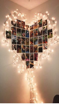 a heart shaped photo collage with lights hanging from the wall and pictures on it