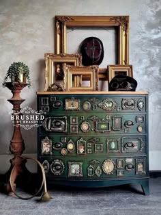 there is a green dresser with many pictures on it