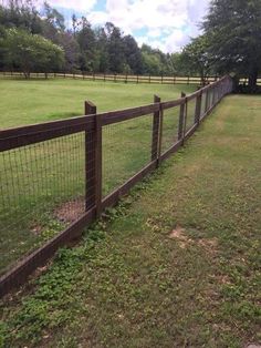 a fence in the middle of a grassy field