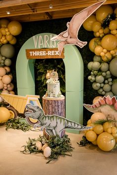 a dinosaur themed birthday party with balloons and decorations