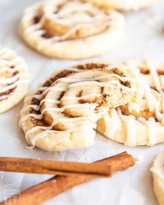 cinnamon roll cookies with icing and cinnamon sticks