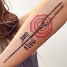 a woman's arm with an arrow and rose tattoo on it