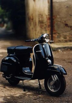 a black scooter is parked on the street