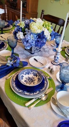 the table is set with blue and white dishes