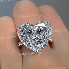 Handmade 11.5 CT Moissanite heart shaped ring,white gold,hidden halo heart engagement ring,celebrity style big large heart moissanite wedding ring → Occasions: Engagement & Wedding DESCRIPTION  -------------------- STYLE                                     :Solitaire/hidden halo ●𝐂𝐞𝐧𝐭𝐞𝐫 𝐒𝐭𝐨𝐧𝐞 𝐃𝐞𝐭𝐚𝐢𝐥𝐬 →Stone Type      :Moissanite - High Quality →Main Stone      :Heart →Size (mm)        :14*14 →Carat Weight   :11.5  ●𝐌𝐚𝐢𝐧 𝐬𝐭𝐨𝐧𝐞 𝐨𝐩𝐭𝐢𝐨𝐧 𝐢𝐧 𝐂𝐓        8.5 CT = 12.7 Big Heart Ring, Luxury Heart Cut Diamond Wedding Ring, Huge Heart Shaped Engagement Rings Luxury, Luxury Heart Cut Sparkling Stones Jewelry, Massive Engagement Rings, Luxury Heart-shaped Engagement Ring, Heart-shaped Moissanite For Valentine's Day Wedding, Luxury Heart-shaped Center Stone Wedding Ring, Moissanite Heart Cut Diamond Ring For Valentine's Day