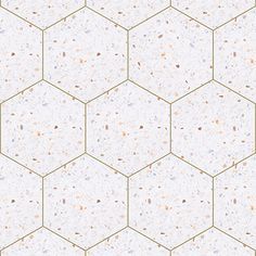 a white and gold hexagonal tile wallpaper with small speckles on it