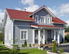 a gray house with red roof and white trim