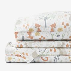 sheet set with woodland animals and trees on them, folded in two rows next to each other