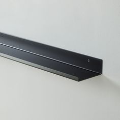 a metal shelf mounted on the wall