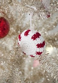 the ornaments on this christmas tree are crocheted with red, white and silver yarn