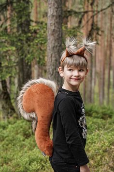 a young boy with a squirrel tail on his back