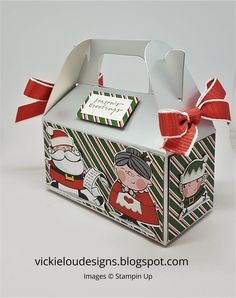 a small christmas box with santa and mrs claus on it