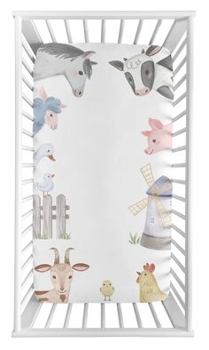 a baby crib with farm animals on the sides and an animal themed border around it