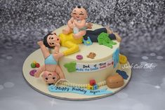 there is a cake that has people on it and some toys in the shape of babies