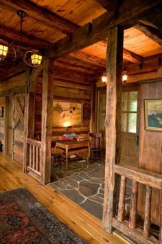 the inside of a log cabin with stone flooring and wood trimming on the walls