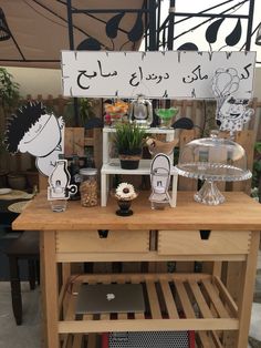 a wooden table topped with an apple computer and lots of decorations on top of it