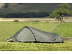 a tent is pitched up in the grass