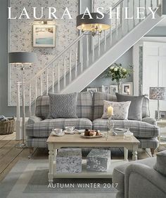 a living room filled with furniture next to a stair case