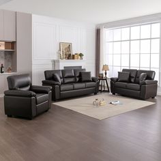 a living room filled with black leather furniture