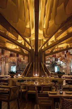 the inside of a restaurant with wooden tables and wicker umbrellas hanging from the ceiling