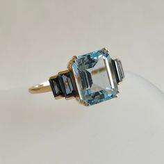 This stunning ring is set in 14k Solid Yellow Gold with Natural Sky Blue topaz and London Blue topaz with utmost precision.  It is an unique statement gemstone ring for nearly every occasion and is completely hassle-free jewelry.  ITEM DETAILS: * CENTER GEM: Sky Blue topaz * GEM SIZE: 8X10mm * GEM SHAPE: Octagon  * SIDE GEM: London Blue topaz * GEM SIZE: 5x2.5mm (2pcs) and 4x2mm (2pcs) * GEM SHAPE: Baguette * Total Gem weight: 5.25 carats * Gold Purity: 14KT (58.33% approx.) * Gold Weight: 1.55 Luxury Elegant Polished Topaz Ring, Luxury Gold Topaz Ring Timeless Style, Luxury Elegant Topaz Ring With Large Stone, Luxury Topaz Crystal Ring, Blue Topaz Baguette Cut Ring In 14k Gold, Blue Topaz Multi-stone Ring In 14k Gold, Modern Blue Topaz Ring In 14k Gold, Blue Topaz Ring With Baguette Cut, Art Deco Blue Topaz Ring With Accent Stones