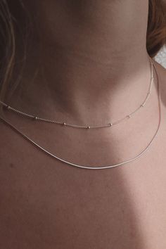 Sleek and minimal, this 1mm thick snake chain is great for layering with other necklaces. Add a pendant to it or wear it by itself. - Sterling Silver or 14K Gold-Filled - 16" or 18" long Jewelry Care All items, excluding one-of-a-kind and ready-to-ship pieces, are Made to Order and take 1-4 weeks to process before shipping. Items currently in stock will ship within 1-5 business days. All items are final sale. Please confirm your ring size before purchasing. Minimalist Snake Chain Necklaces For Layering, Delicate Snake Chain Jewelry For Layering, Dainty Snake Chain Jewelry For Layering, Layering Delicate Snake Chain Jewelry, Minimalist Double Chain Herringbone Necklace, Dainty Snake Chain Necklace For Layering, Minimalist Snake Chain Necklace For Layering, Layering Snake Chain Necklace, Minimalist Double Chain Herringbone Necklace For Layering