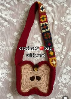 a crocheted bag with a monkey face on the front, and a flowered handle