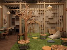 a room with tables, chairs and shelves in the shape of tree trunks is shown