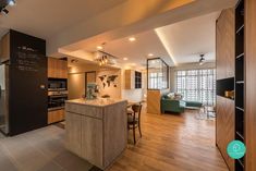 an open concept kitchen and living room with wood flooring