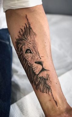 a man's arm with a lion tattoo on it