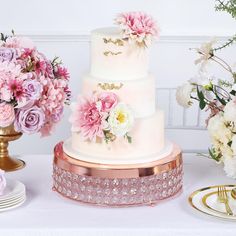 PRICES MAY VARY. Quantity: 1 Cake Stand Material: Metal with Acrylic Crystals Color: Rose Gold | Blush Total Height: 4" Top Diameter: 13.5" Platform Band Thickness: 1" Total Crystals: 165 Crystals Stacked in 3 Layers (55 Pcs / Layer) Strong, durable, and perfect for dining events. Crystal Cake Stand comes with 4 elevated rounded feet HIGH QUALITY: These cake display stands are made from high-quality premium material. To make things swankier, we have designed it on the master of luster. This eleg Pink And Gold Cake Stand, Rose Gold Cake Stand, Beaded Cake Stand, Unique Cake Stands, Gem Cake, Square Cake Stand, Bling Cakes, Crystal Cake Stand, Dessert Display Stand