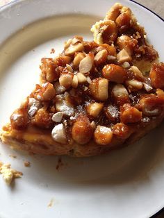 a piece of pie on a plate with nuts