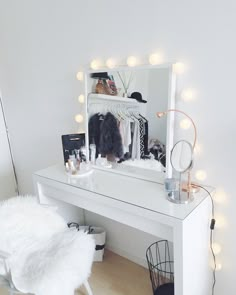 a white desk with a mirror and lights on it