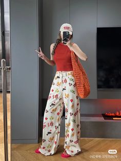 a woman standing in front of a fire place holding a cell phone