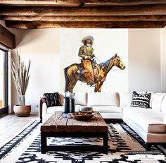 a living room filled with furniture and a painting on the wall