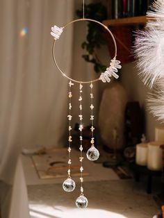 a wind chime hanging from the ceiling in front of a white christmas tree with snowflakes on it