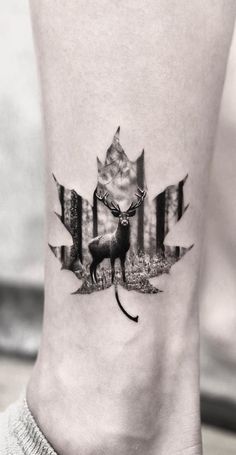 a black and white photo of a canadian flag with a wolf tattoo on the ankle