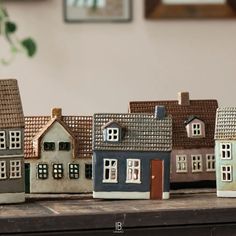 a group of small houses sitting on top of a wooden table