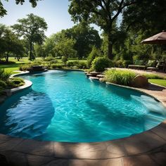 an empty swimming pool surrounded by lush green trees